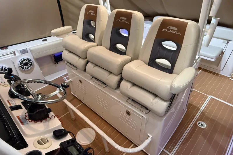 Slide: The Image of 2021 Cobia 350 CC boat interior with plush seating and modern steering console. - 18