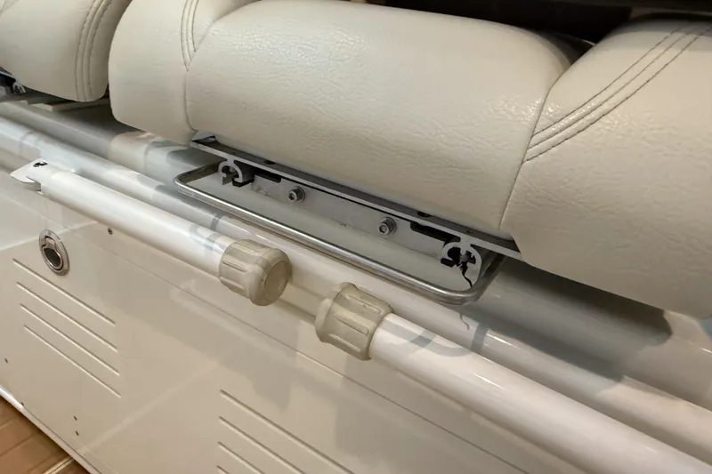 Slide: The Image of Cobia 350 CC 2021 boat seat detail with white upholstery and metal fittings. - 19