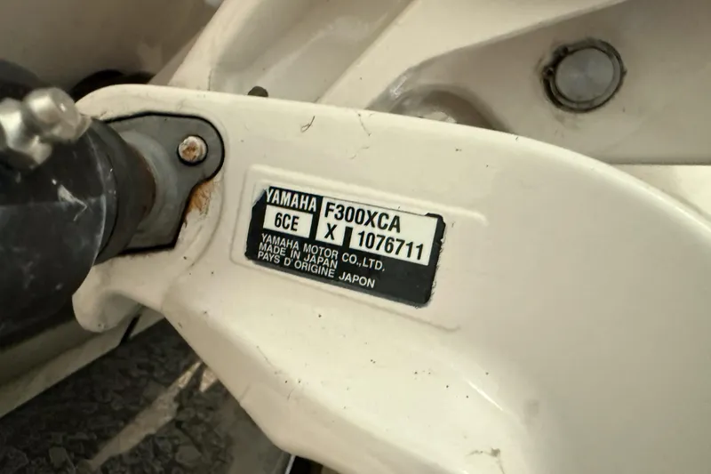 Slide: The Image of Yamaha F300XCA engine label on 2021 Cobia 350 CC boat, close-up view. - 2