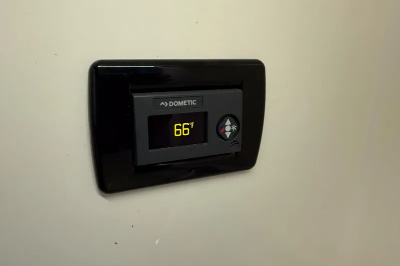 Slide: The Image of Dometic thermostat displaying 66°F in 2021 Cobia 350 CC boat. - 20