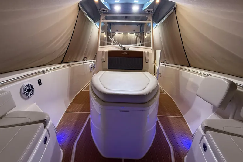 Slide: The Image of 2021 Cobia 350 CC boat interior with elegant seating and ambient lighting. - 23