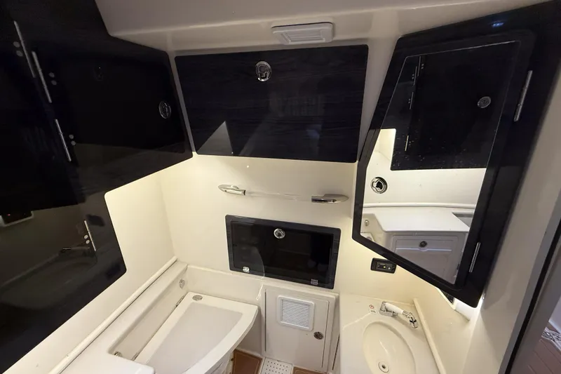 Slide: The Image of 2021 Cobia 350 CC boat interior with modern cabinetry and sink area. - 28