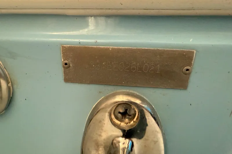 Slide: The Image of 2021 Cobia 350 CC boat identification plate on light blue surface. - 34