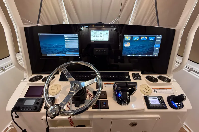 Slide: The Image of 2021 Cobia 350 CC boat dashboard with advanced navigation and control systems. - 6