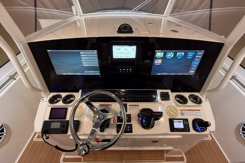 Slide: The Image of 2021 Cobia 350 CC boat dashboard with advanced navigation and control systems. - 8