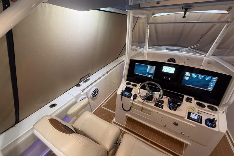 Slide: The Image of 2021 Cobia 350 CC boat cockpit with advanced navigation displays and controls. - 9