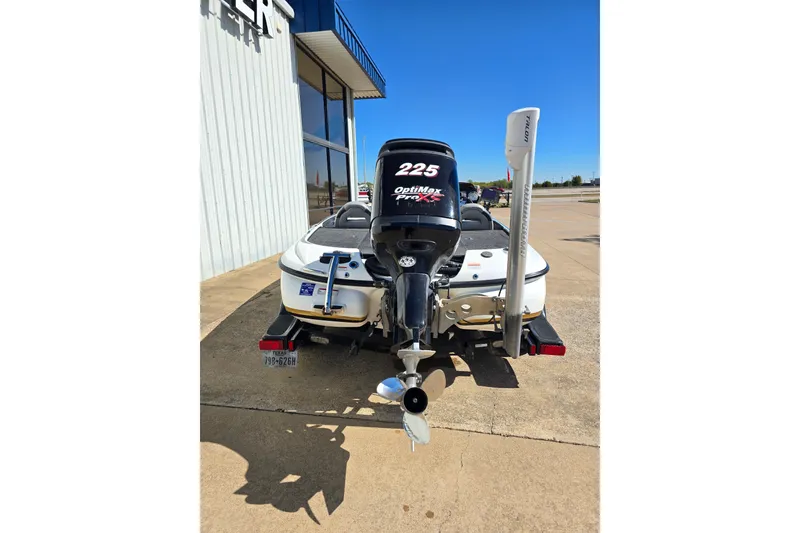 Slide: The Image of 2010 Nitro Z-9 boat with OptiMax Pro XS engine, parked outside a building. - 2