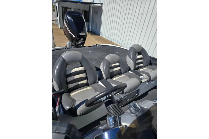 Slide: The Image of 2010 Nitro Z-9 boat interior with Mercury engine, featuring gray and white seating. - 5