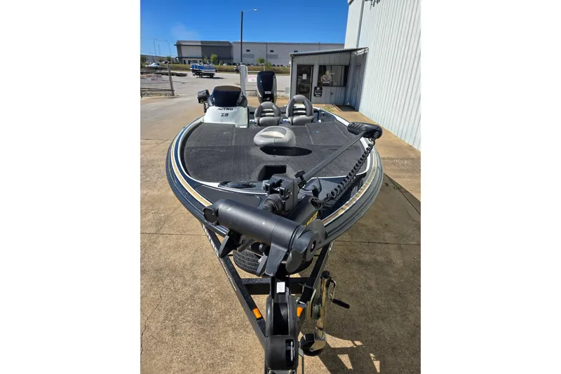 Slide: The Image of 2010 Nitro Z-9 boat parked outside a building on a sunny day. - 6