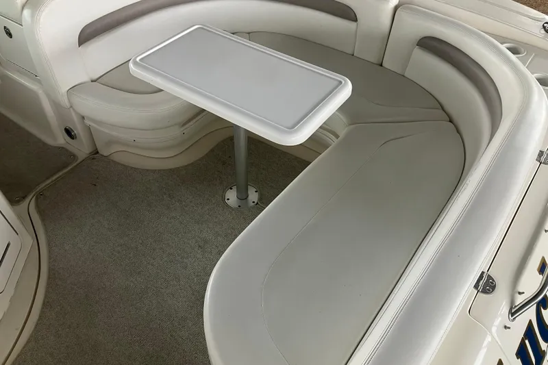Slide: The Image of 2004 Sea Ray 320 Sundancer interior with white seating and table. - 10