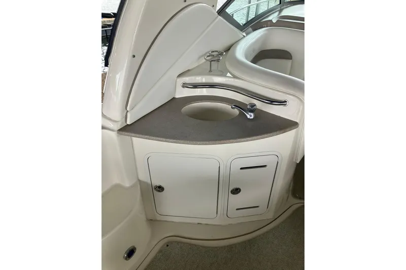 Slide: The Image of 2004 Sea Ray 320 Sundancer boat interior with sink and storage cabinets. - 11