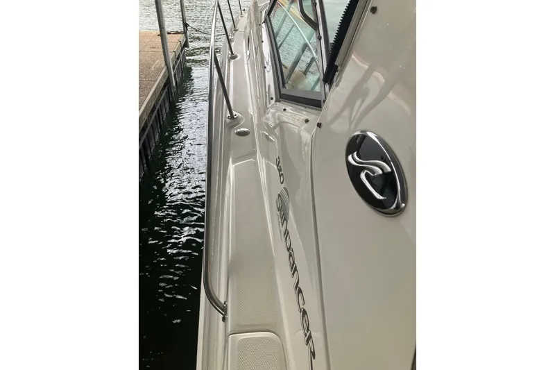 Slide: The Image of 2004 Sea Ray 320 Sundancer docked, showcasing sleek design and logo. - 19