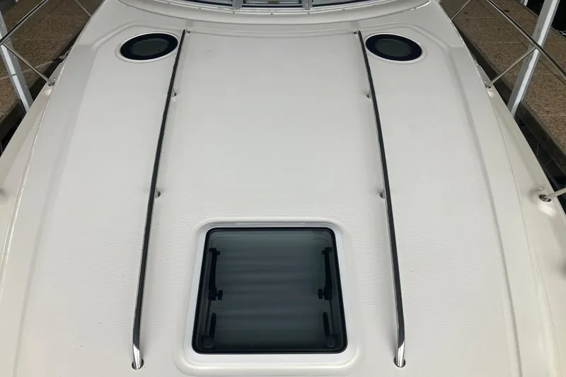 Slide: The Image of 2004 Sea Ray 320 Sundancer boat deck with hatch and railings. - 22