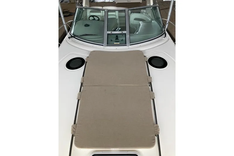 Slide: The Image of 2004 Sea Ray 320 Sundancer boat with sunpad and windshield, showcasing sleek design. - 24