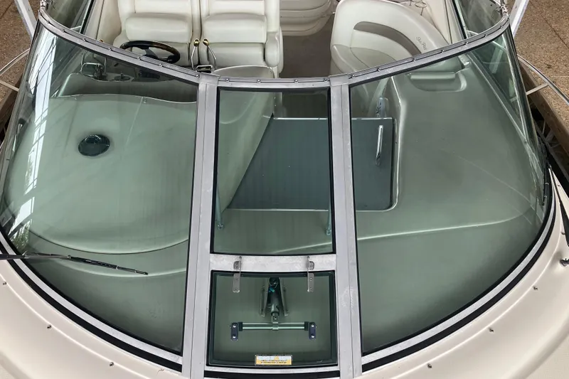 Slide: The Image of 2004 Sea Ray 320 Sundancer boat interior with windshield and seating view. - 25
