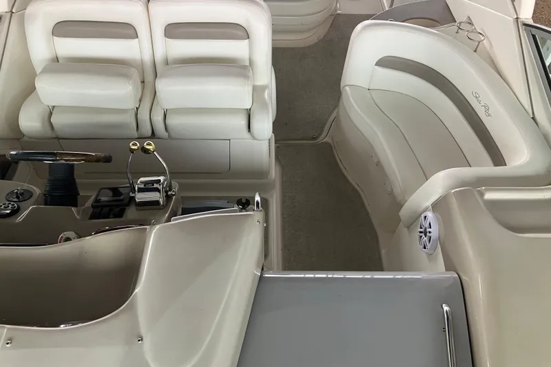 Slide: The Image of Interior of a 2004 Sea Ray 320 Sundancer boat, featuring helm and seating area. - 26