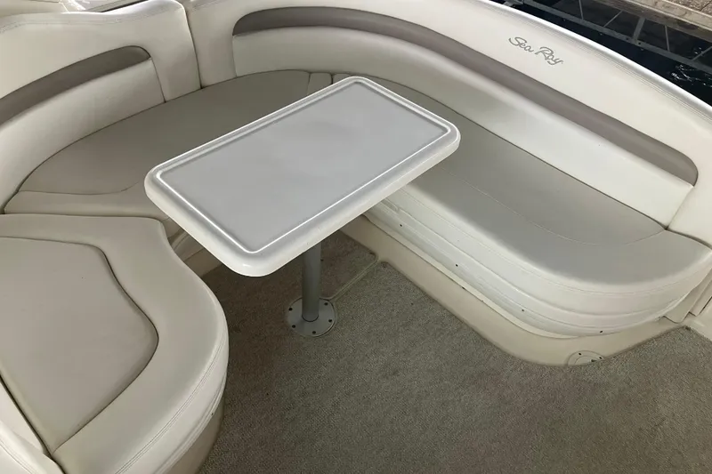 Slide: The Image of 2004 Sea Ray 320 Sundancer interior with white seating and table. - 27