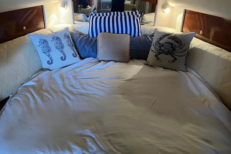 Slide: The Image of Cozy cabin bed with nautical-themed pillows in 2004 Sea Ray 320 Sundancer yacht. - 33