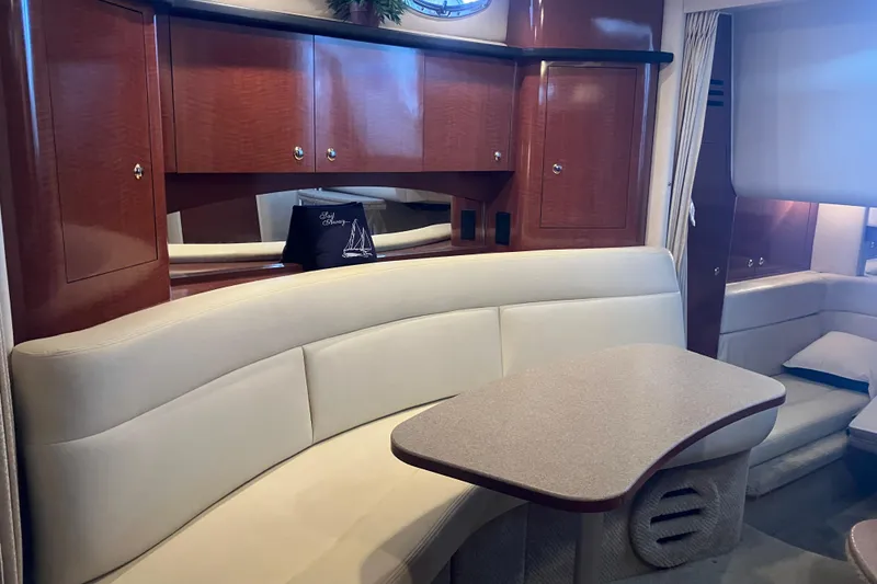 Slide: The Image of 2004 Sea Ray 320 Sundancer interior with elegant seating and wooden cabinetry. - 34