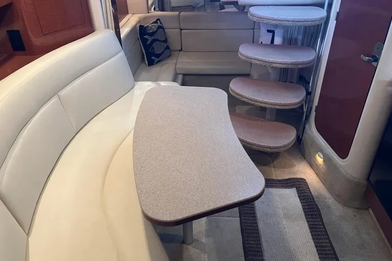 Slide: The Image of Interior of 2004 Sea Ray 320 Sundancer with curved seating and steps. - 36