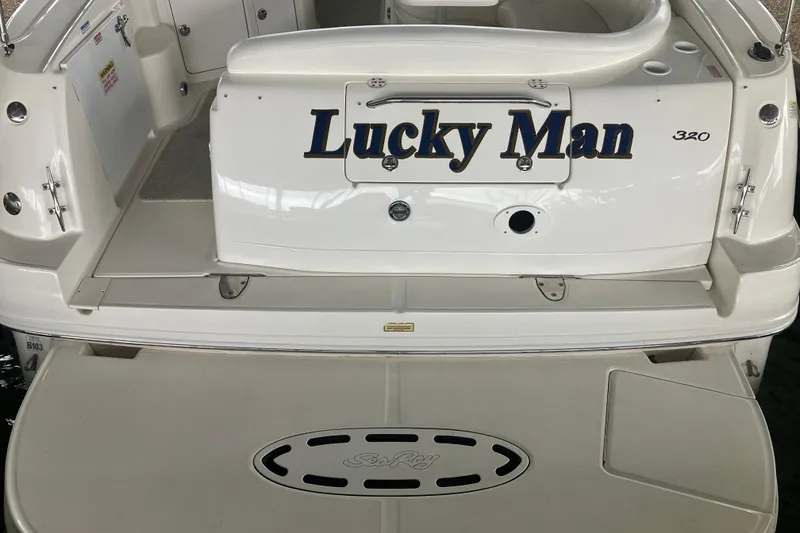 Slide: The Image of Rear view of 2004 Sea Ray 320 Sundancer boat named "Lucky Man." - 8