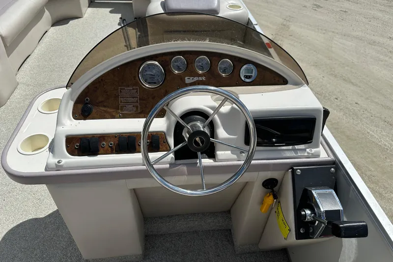 Slide: The Image of Steering console of a 2003 Crest 25 II LM boat with gauges and controls. - 10