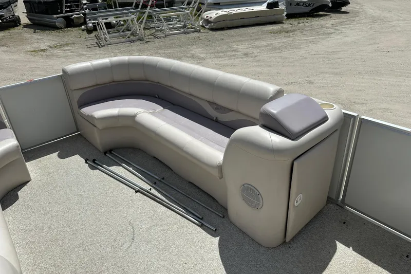 Slide: The Image of 2003 Crest 25 II LM boat interior with beige seating and storage compartment. - 16