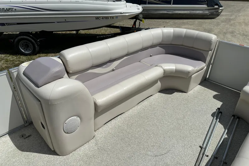 Slide: The Image of 2003 Crest 25 II LM pontoon boat with beige seating and carpeted deck. - 17