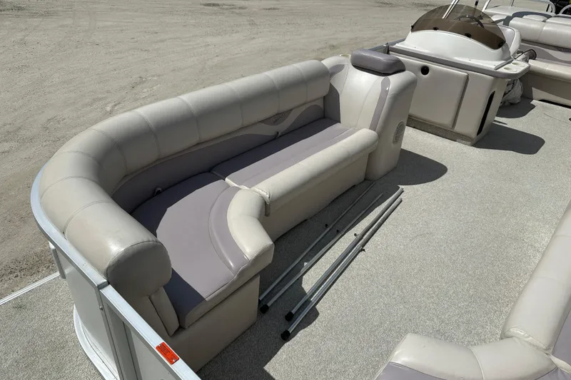 Slide: The Image of 2003 Crest 25 II LM pontoon boat interior with cushioned seating and helm. - 5