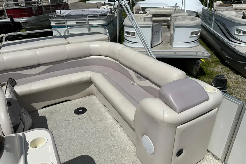 Slide: The Image of 2003 Crest 25 II LM pontoon boat with beige seating and cup holders. - 6