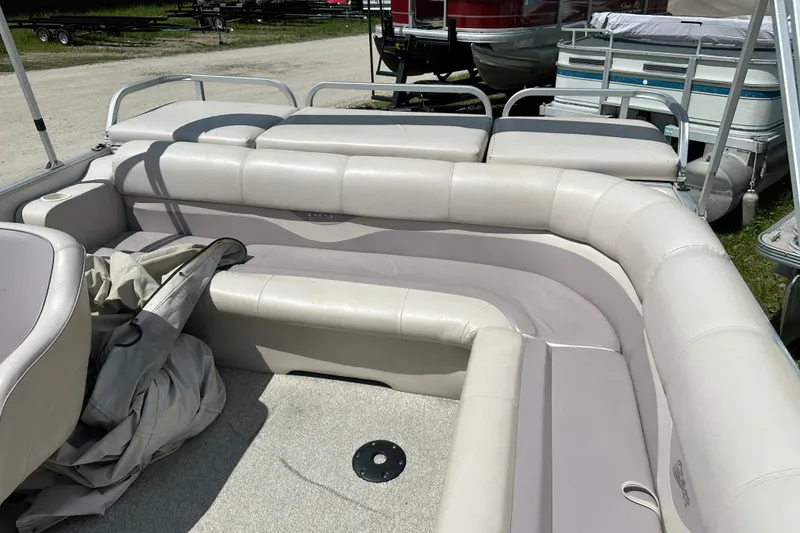 Slide: The Image of 2003 Crest 25 II LM pontoon boat interior with beige seating and carpeted floor. - 7