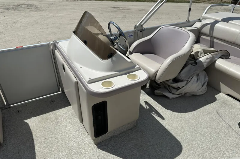 Slide: The Image of 2003 Crest 25 II LM boat interior with steering console and seating area. - 9