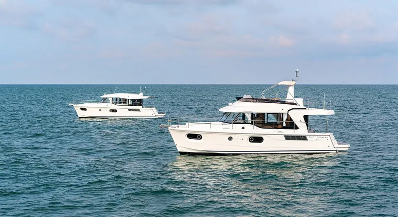 Slide: The Image of Two 2025 Beneteau Swift Trawler 41 Fly boats cruising on open water. - 17