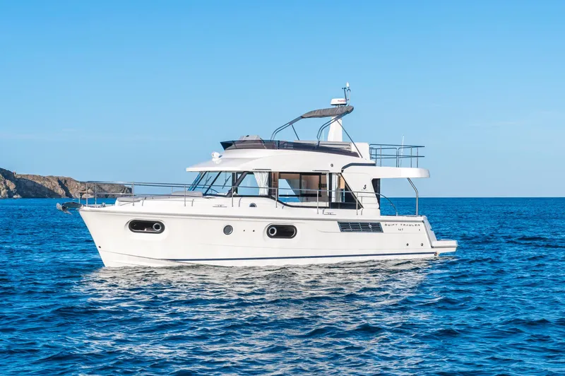 Slide: The Image of 2025 Beneteau Swift Trawler 41 Fly cruising on open sea under clear blue sky. - 20