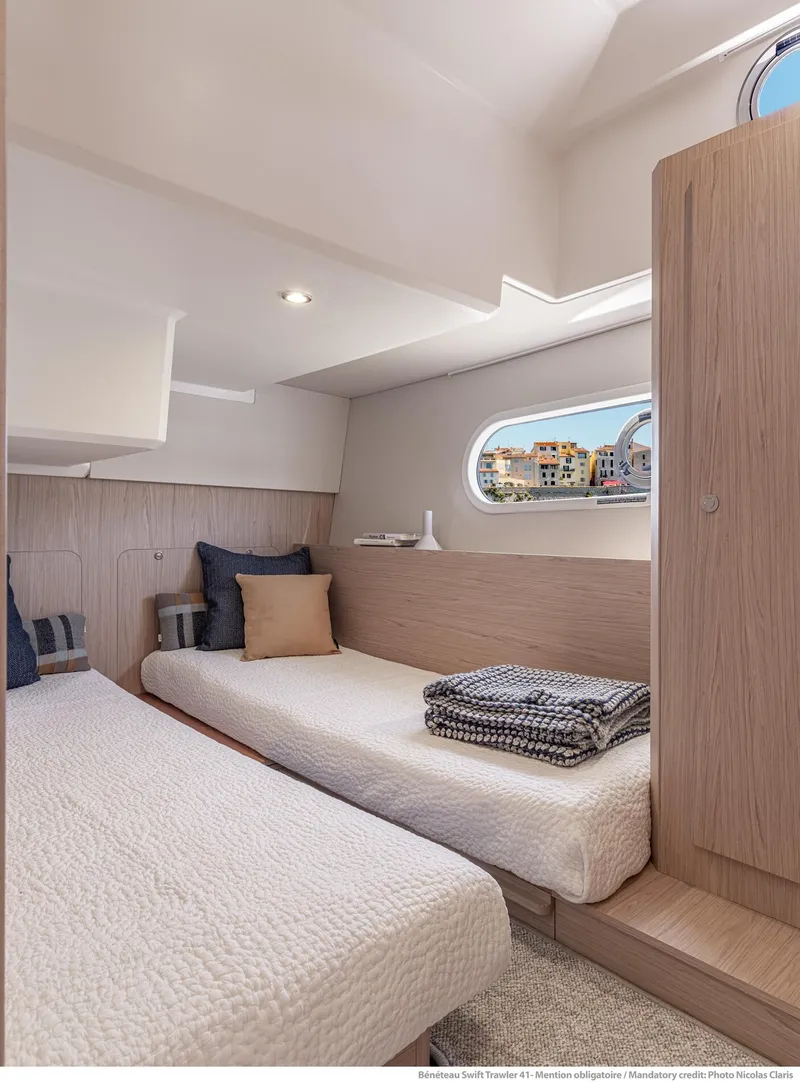 Slide: The Image of 2025 Beneteau Swift Trawler 41 Fly cabin with twin beds and modern decor. - 8