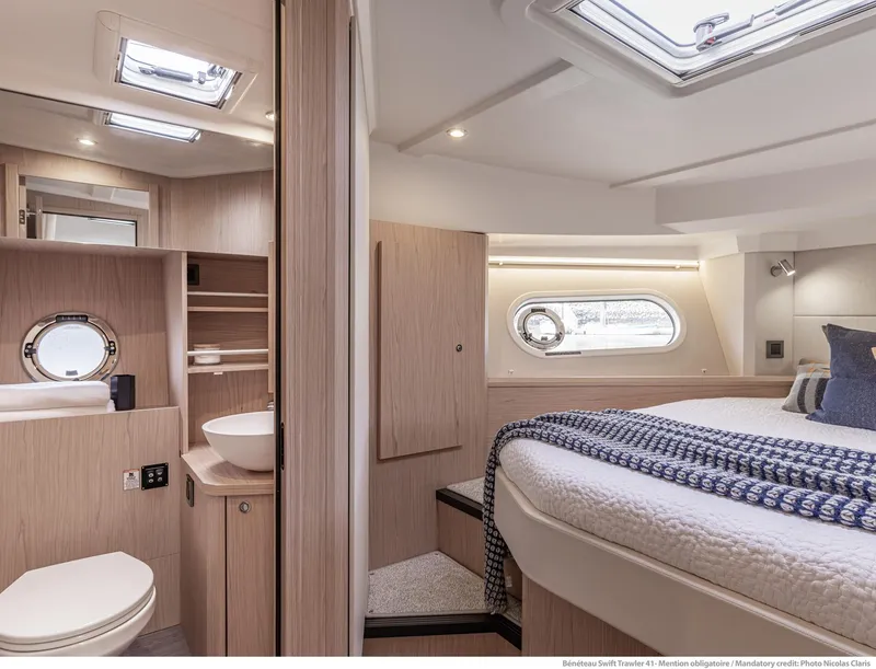 Slide: The Image of Luxurious interior of 2025 Beneteau Swift Trawler 41 Fly with modern bathroom and cozy bedroom. - 7