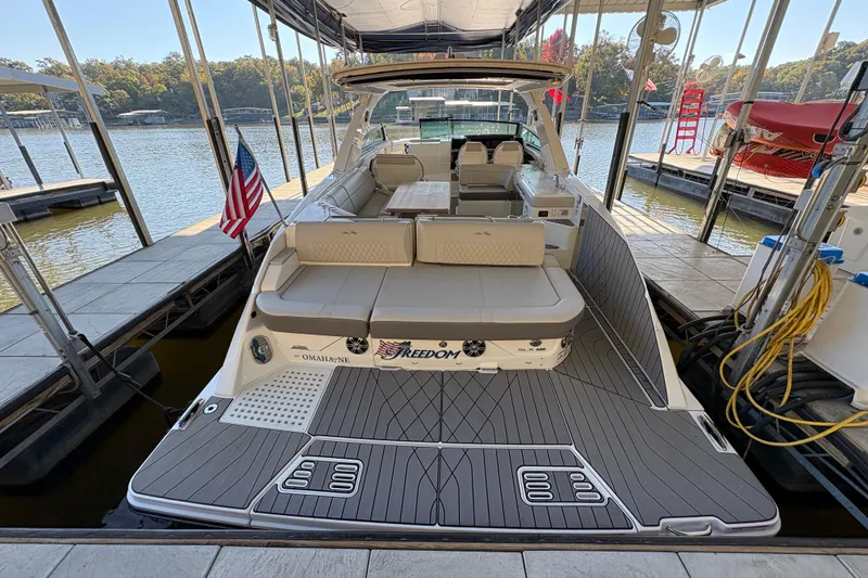 Slide: The Image of 2023 Sea Ray SLX 400 boat with spacious seating and elegant deck design. - 10