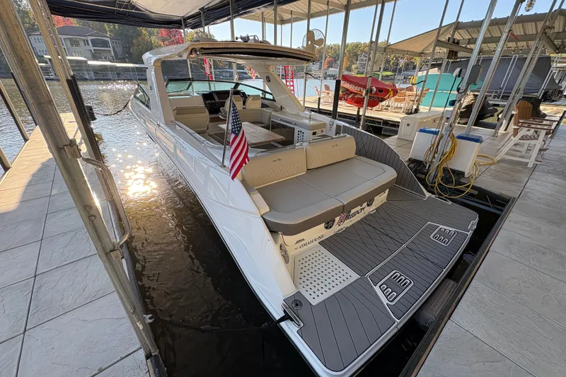 Slide: The Image of 2023 Sea Ray SLX 400 luxury boat docked, featuring spacious seating and sleek design. - 11