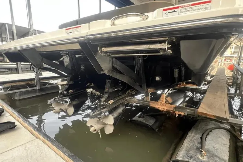 Slide: The Image of 2023 Sea Ray SLX 400 boat docked, featuring spacious seating and American flag. - 12