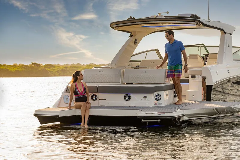 Slide: The Image of Manufacturer Provided Image: 2023 Sea Ray SLX 400 luxury boat with paddleboard on water. - 19