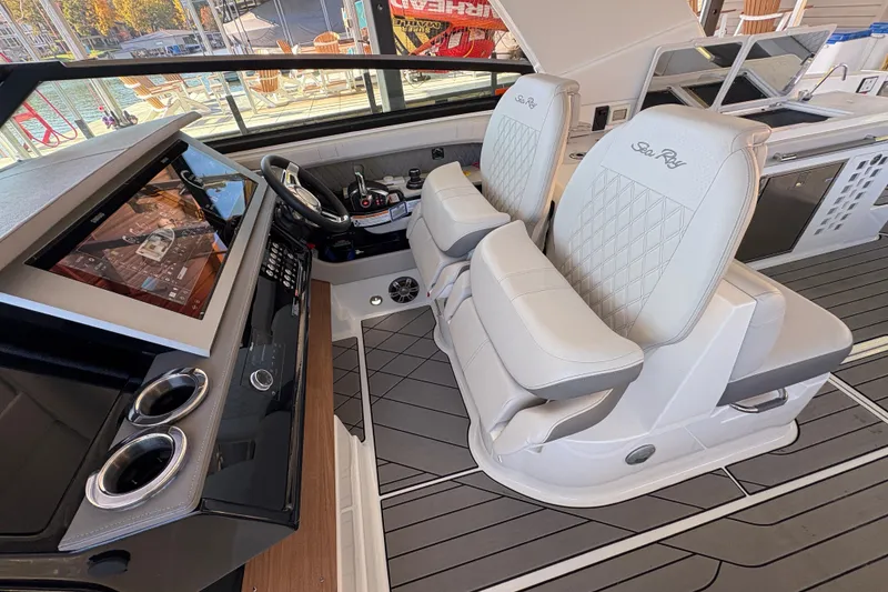 Slide: The Image of 2023 Sea Ray SLX 400 boat interior with dual captain's chairs and modern dashboard. - 21