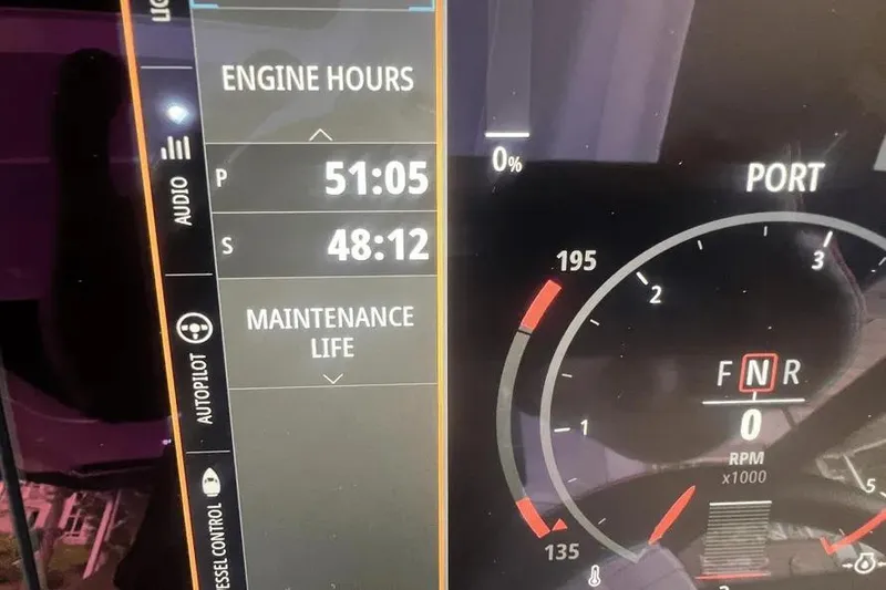 Slide: The Image of 2023 Sea Ray SLX 400 helm with luxurious seating and modern dashboard controls. - 22