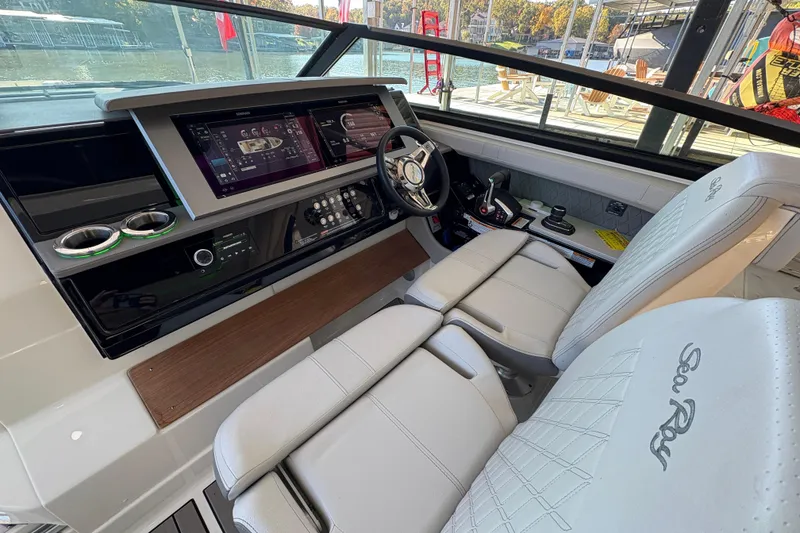 Slide: The Image of 2023 Sea Ray SLX 400 boat interior with luxurious seating and steering wheel. - 24