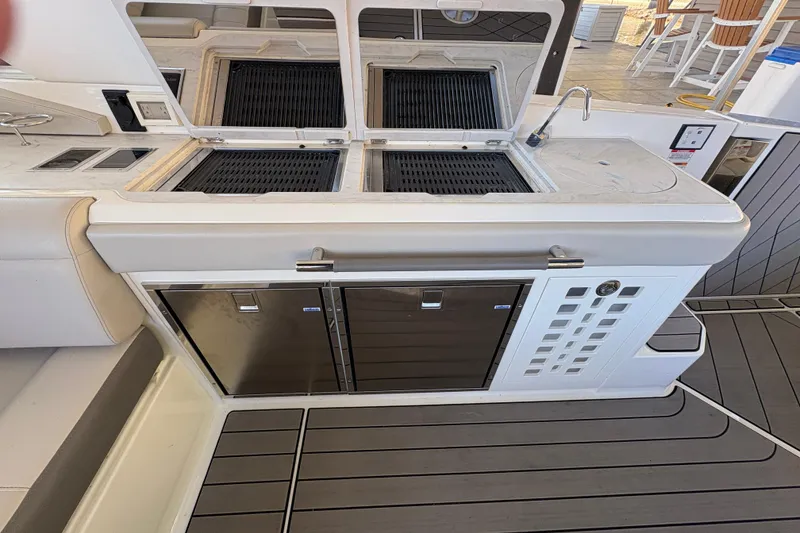 Slide: The Image of Outdoor grill station on 2023 Sea Ray SLX 400 yacht, featuring dual grills and sleek design. - 32