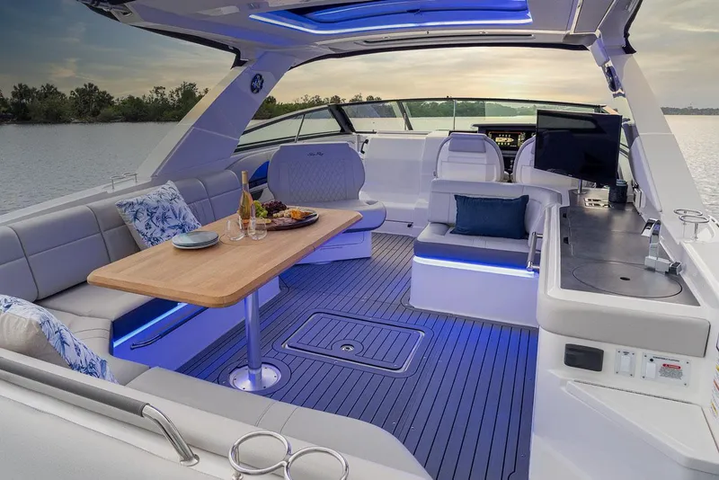 Slide: The Image of Luxurious seating area on 2023 Sea Ray SLX 400 boat, docked by the water. - 35