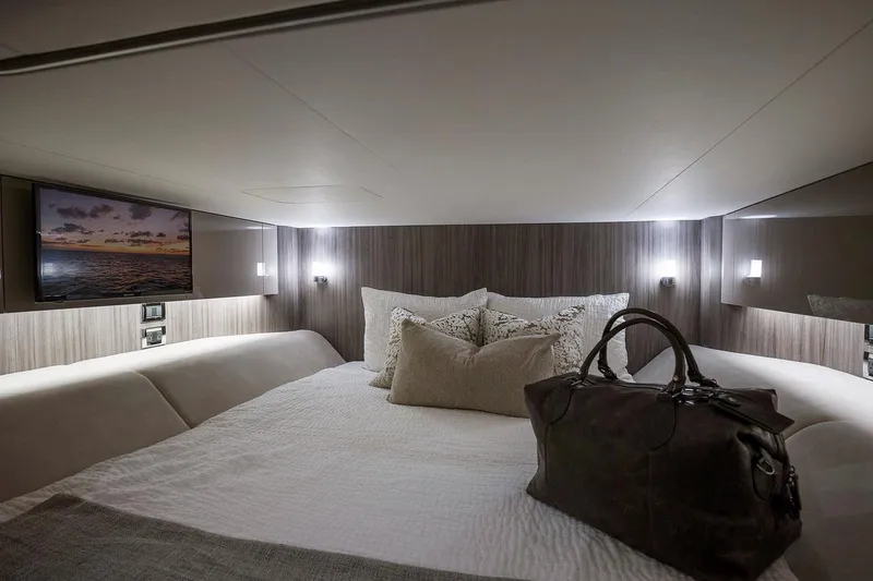 Slide: The Image of Manufacturer Provided Image: Interior cabin of 2023 Sea Ray SLX 400 with bed, stairs, and microwave. - 40