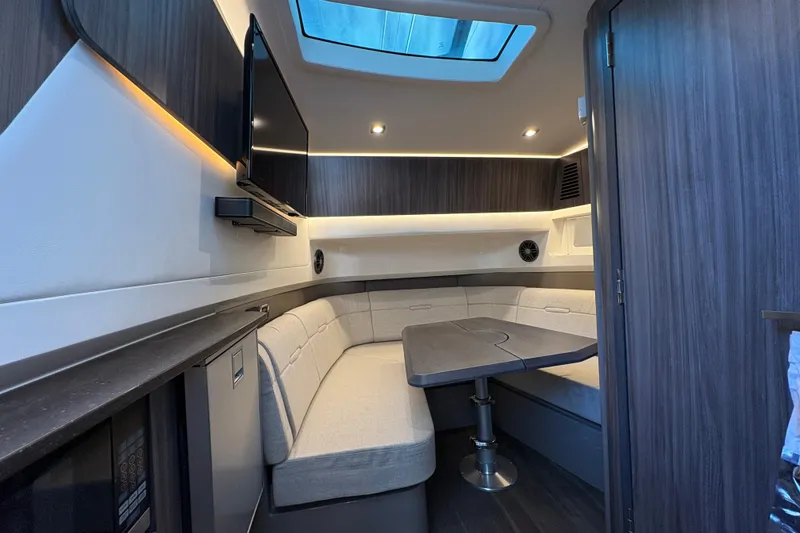 Slide: The Image of Luxurious cabin interior of 2023 Sea Ray SLX 400 with cozy bedding and ambient lighting. - 44