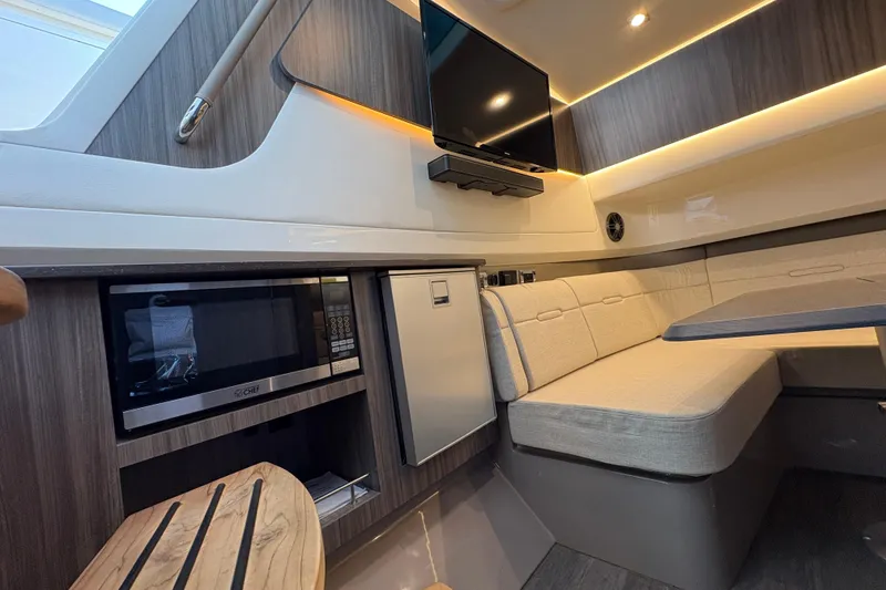 Slide: The Image of Luxurious interior of 2023 Sea Ray SLX 400 yacht with modern seating and skylight. - 45