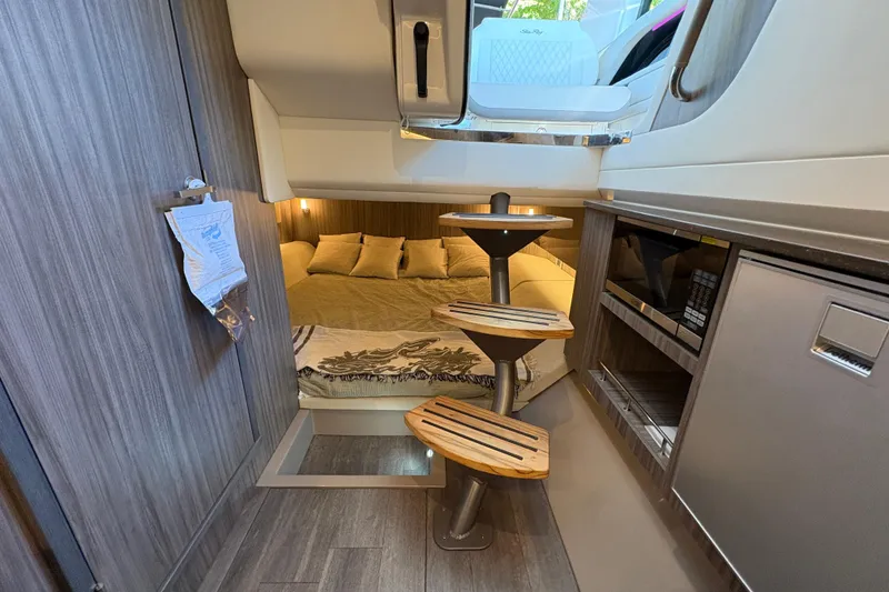 Slide: The Image of 2023 Sea Ray SLX 400 cabin interior with seating, TV, microwave, and modern design. - 46