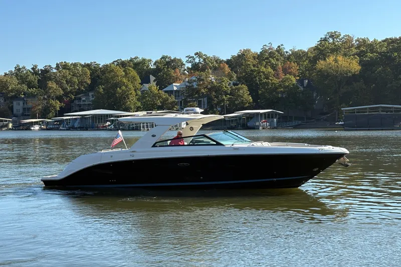 Slide: The Image of 2023 Sea Ray SLX 400 luxury boat interior at a marina dock. - 52